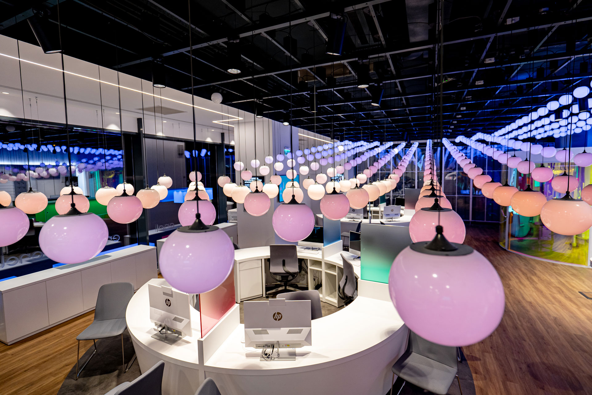 Enel Flagship Store retail project by STIRIXIS Group showing interior with suspended globe lighting installation and open customer experience floor