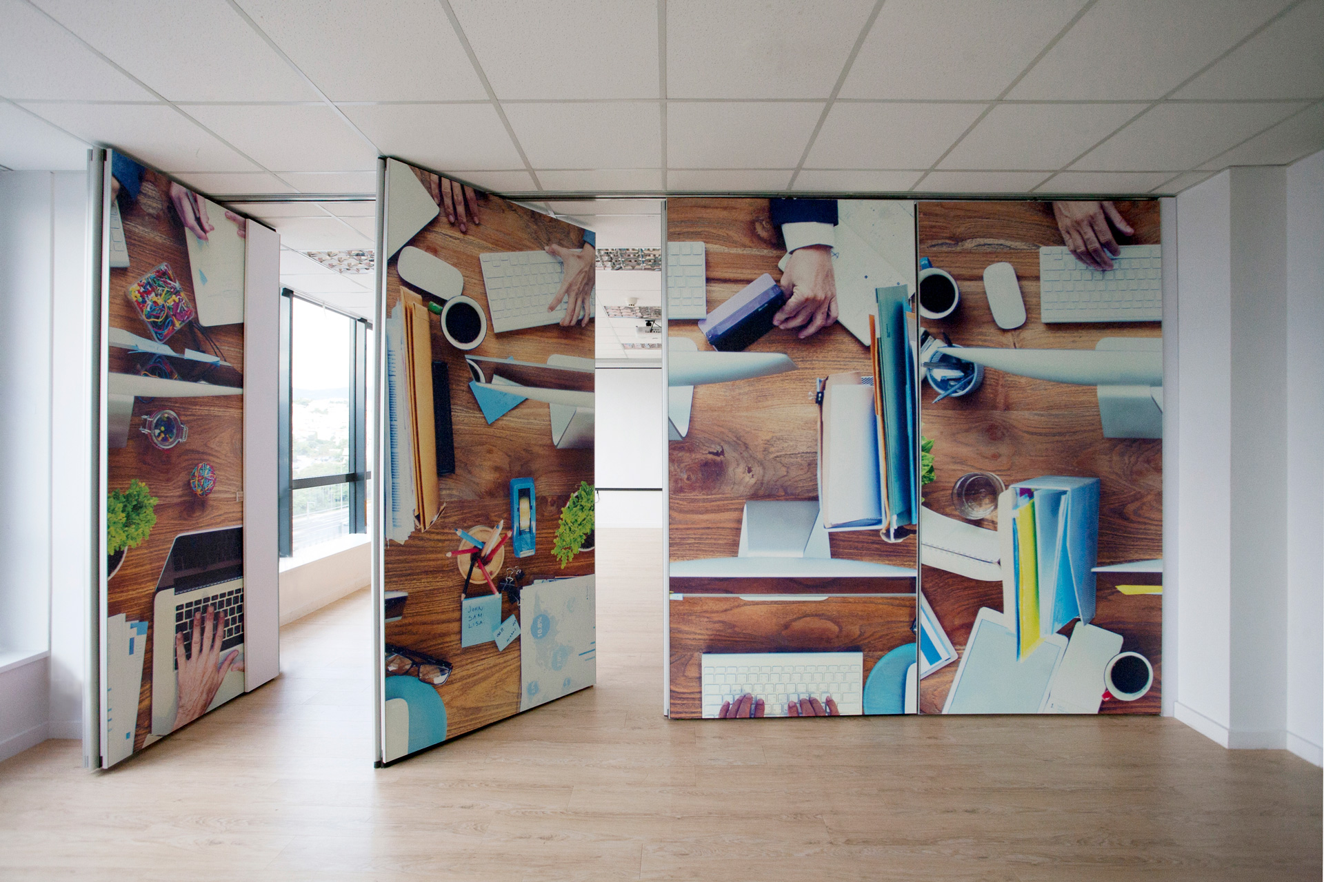 Perrigo Hellas workplace project by STIRIXIS Group showing office corridor with large scale colourful wall art installation