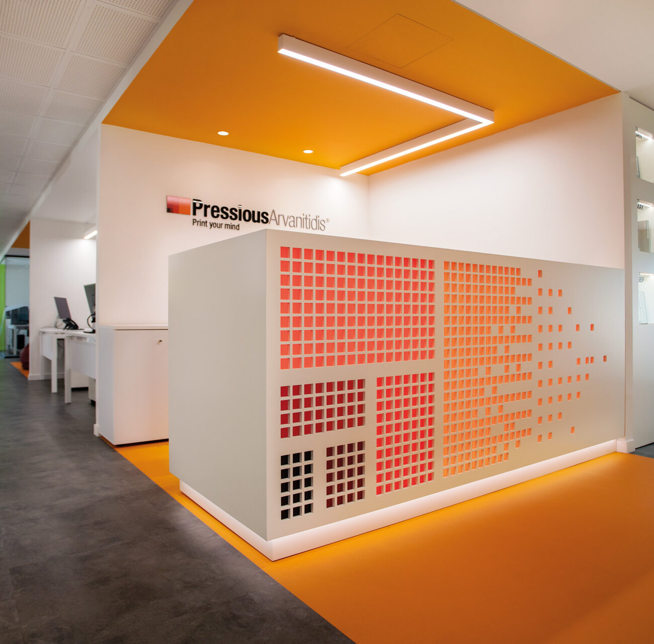 Pressious Arvanitidis workplace project by STIRIXIS Group showing corridor with bold orange brand wall and perforated screen detail