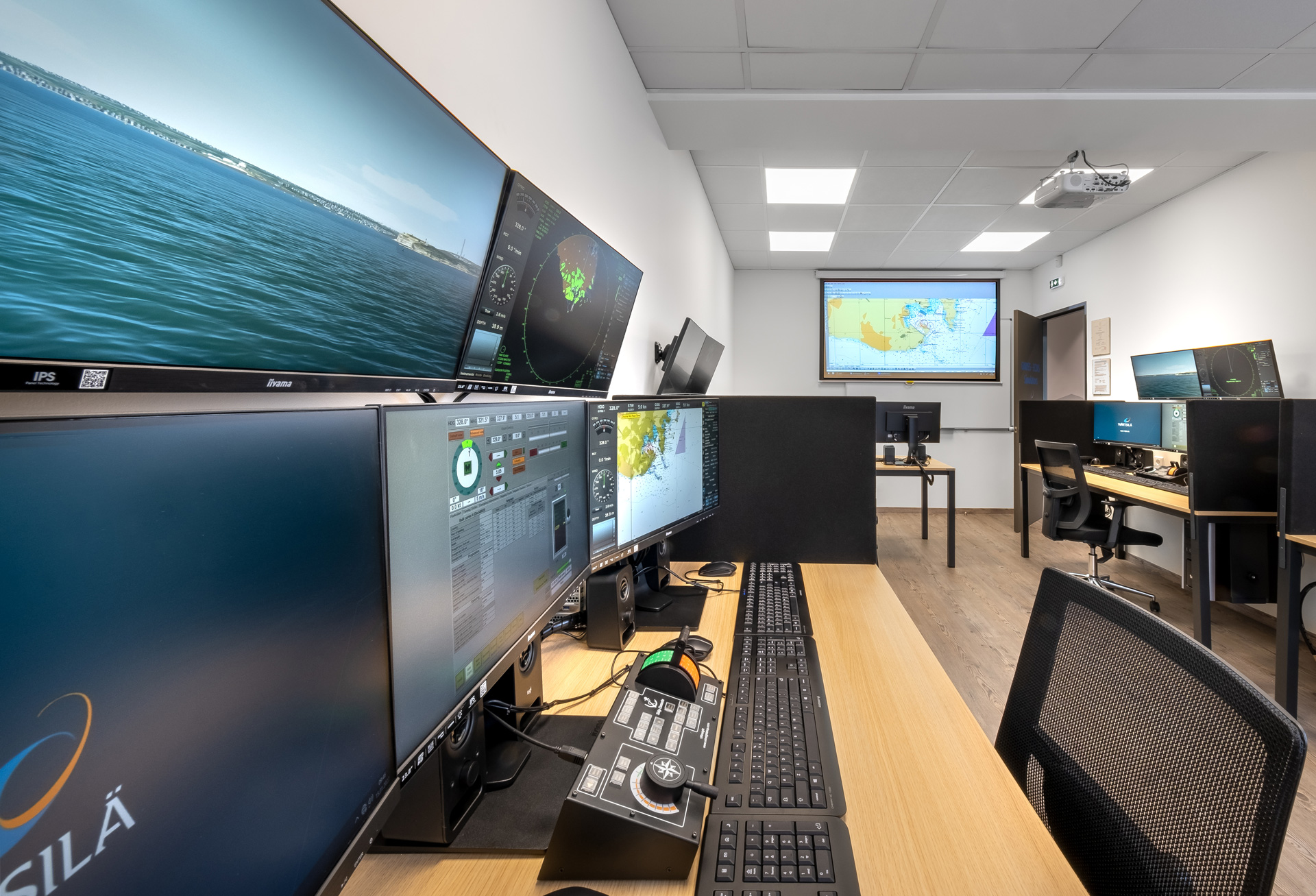 ALS Hellenic Maritime Training Center education project by STIRIXIS Group showing classroom with digital screen wall and navy blue brand identity
