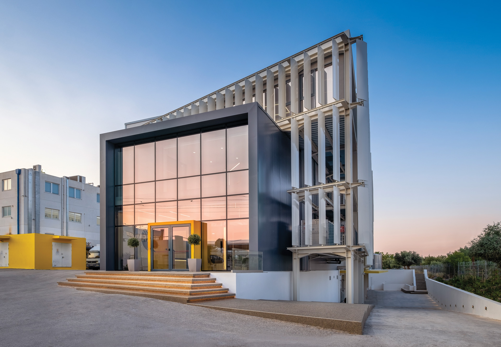 RAFARM R&D building workplace project by STIRIXIS Group showing modern exterior facade with glazed elevations and landscaped surroundings