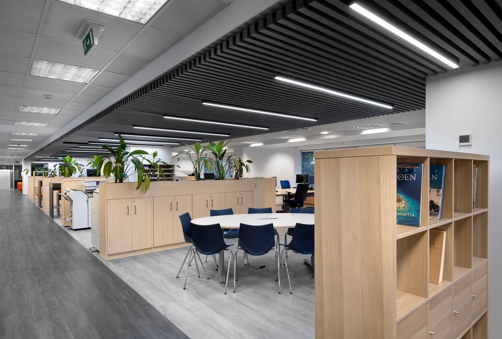 Siemens hybrid office workplace project by STIRIXIS Group showing open office floor with wooden storage units and collaborative workstation layout