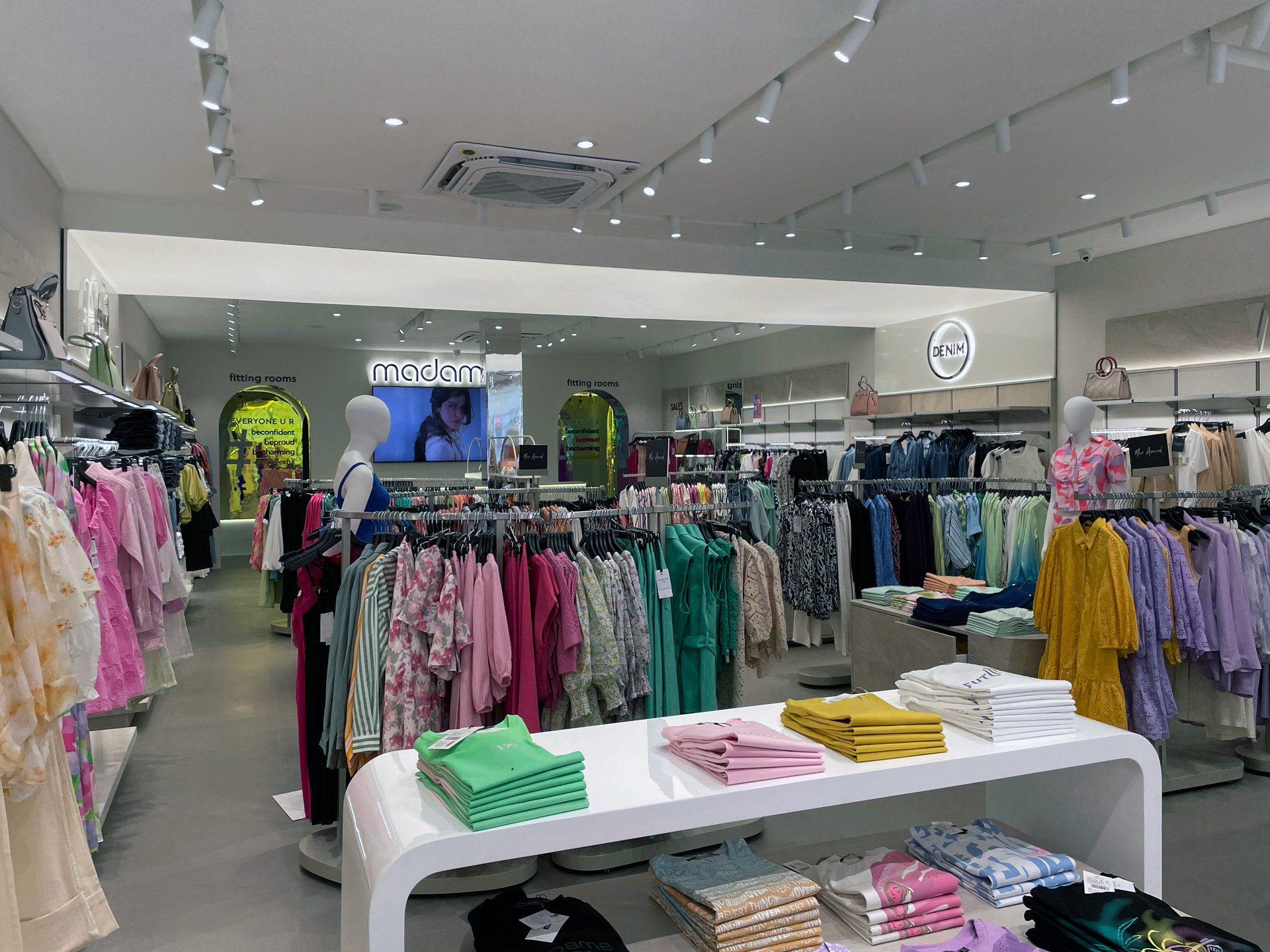 Madame India retail project by STIRIXIS Group showing store interior with fashion rails, natural light from shopfront and colourful collections