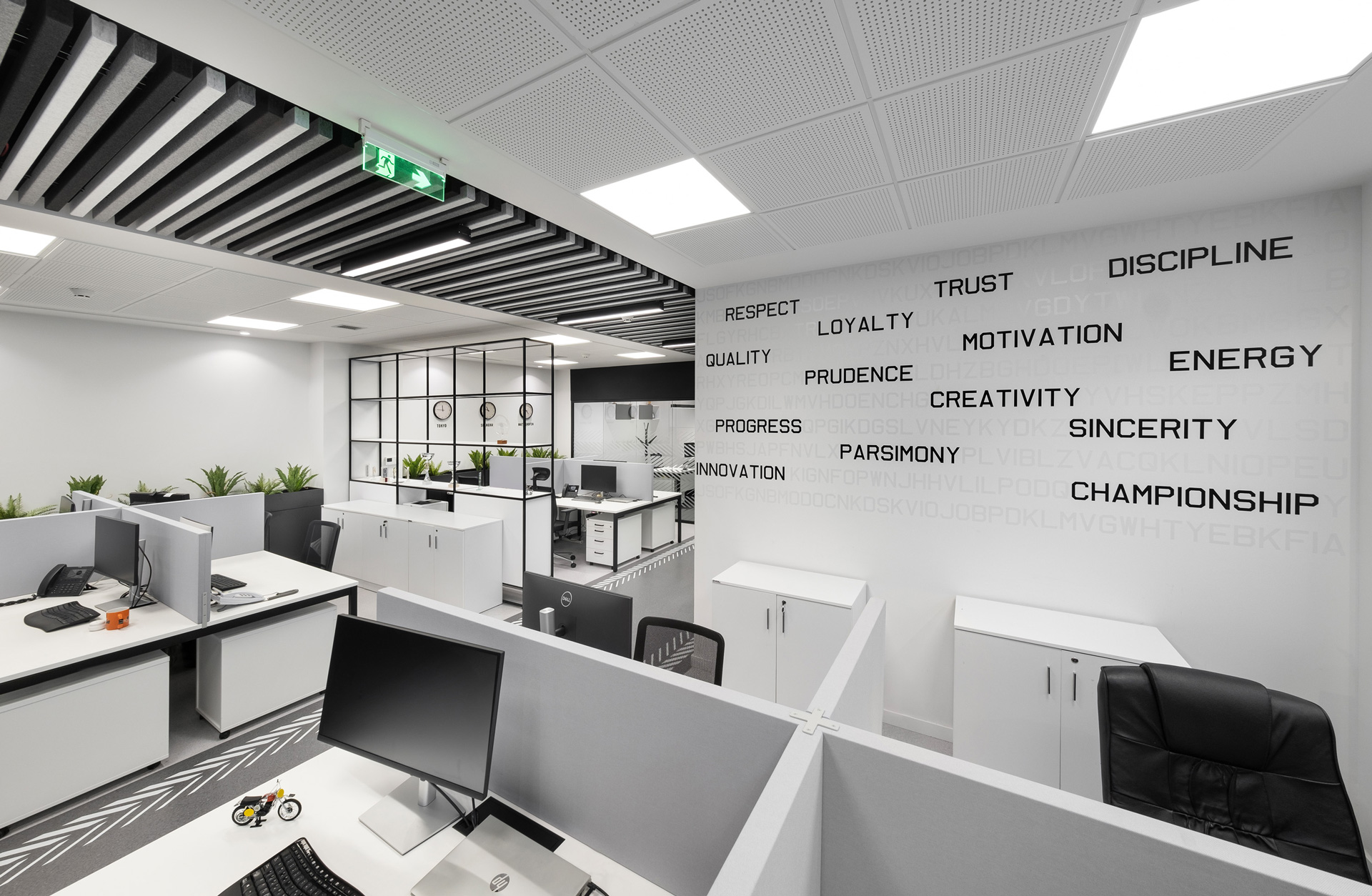Petros Petropoulos workplace project by STIRIXIS Group showing office area with brand values typography wall and open workstation layout