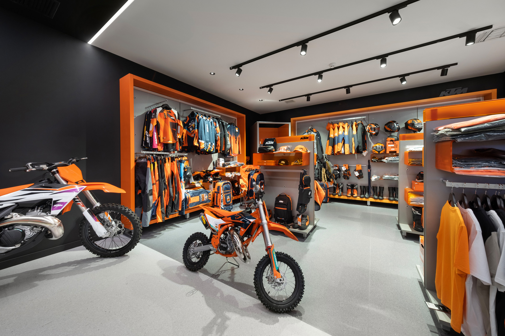 Petros Petropoulos showroom retail project by STIRIXIS Group showing full showroom floor with Husqvarna motorcycles and brand wall display