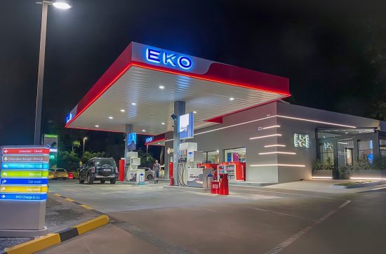 EKO Flagship Station in Kifisia shown at night with illuminated EKO signage, forecourt lighting and exterior station architecture.