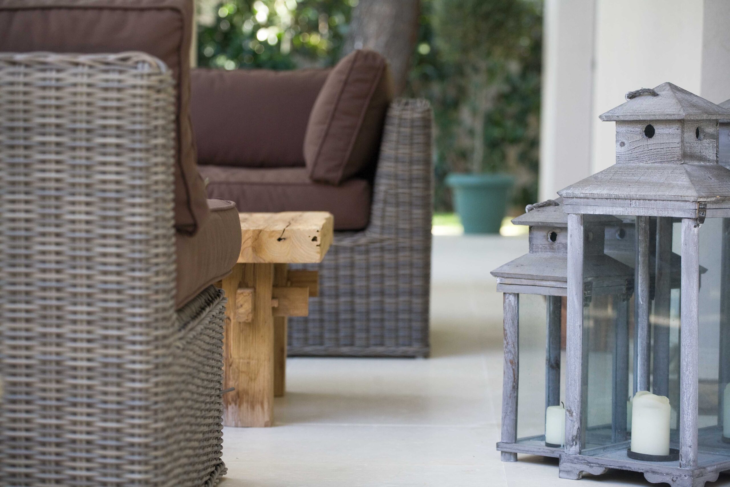 Projection House residential project by STIRIXIS Group showing outdoor seating detail with wicker furniture and decorative lantern