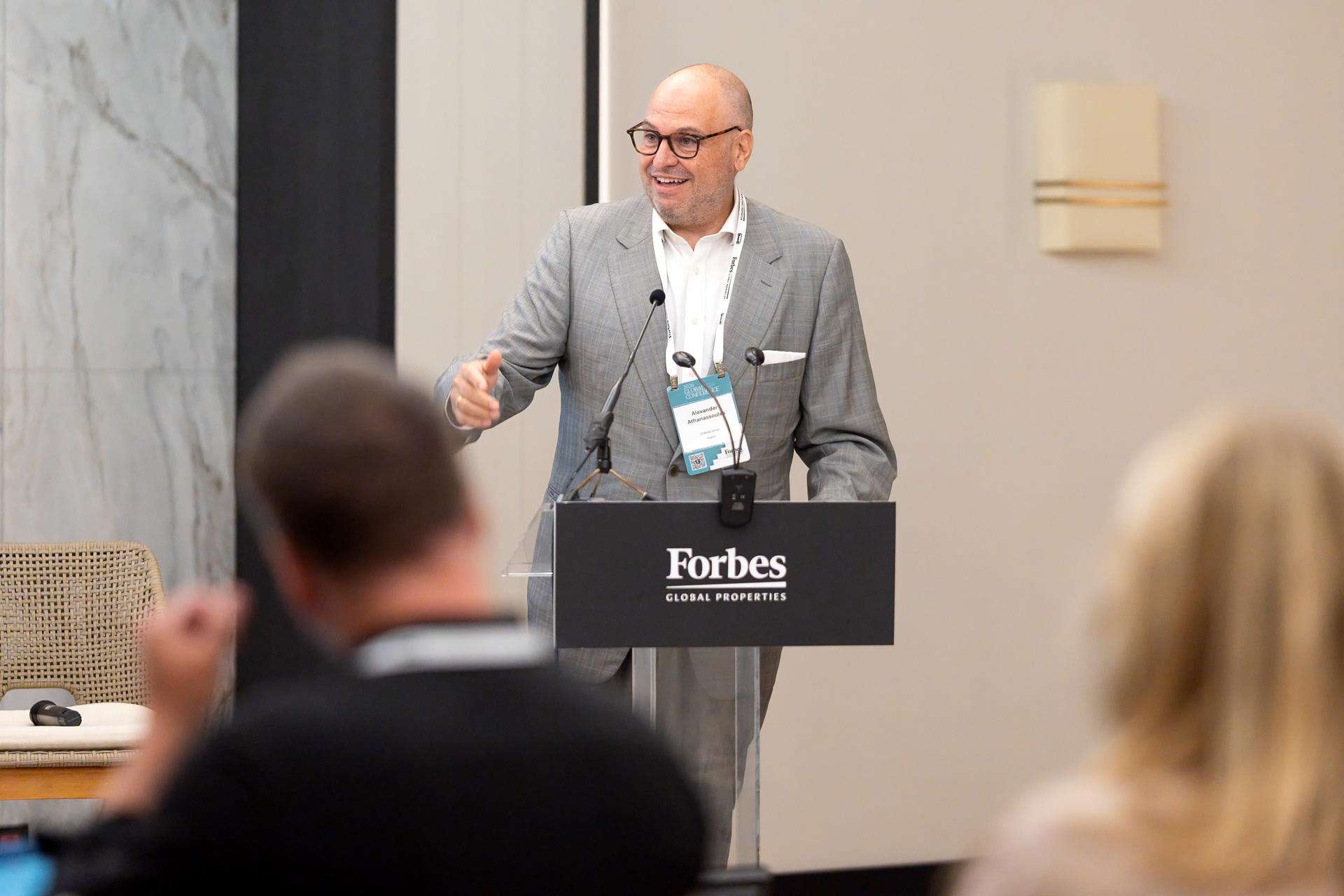 Alex Athanassoulas speaking at the Forbes Global Properties podium during the Annual Global Conference 2026 in Corfu, Greece.Alex Athanassoulas speaking at the Forbes Global Properties podium during the Annual Global Conference 2026 in Corfu, Greece.