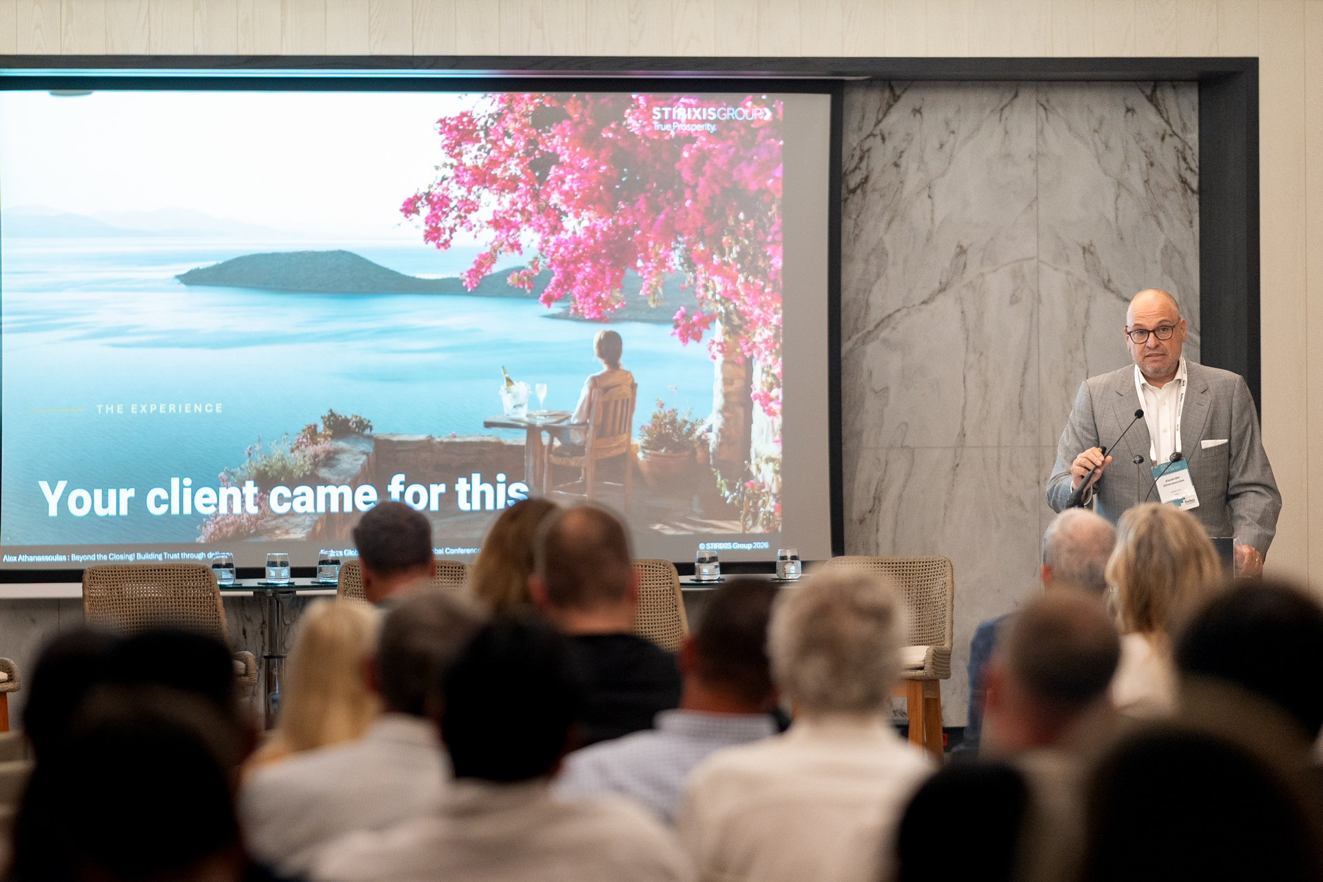 Alex Athanassoulas presenting the STIRIXIS Group keynote to a full audience at the Forbes Global Properties Annual Global Conference 2026 in Corfu, Greece.