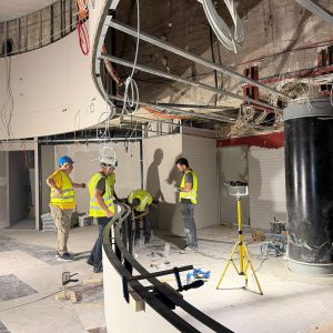 Construction team coordinating specialist works inside an entertainment venue during project delivery.