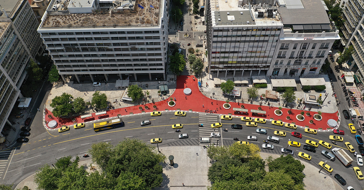 Aerial view of the pedestrian walkway at Syntagma Square in Athens, showing public space, traffic, movement and the urban fabric of the city centre.
