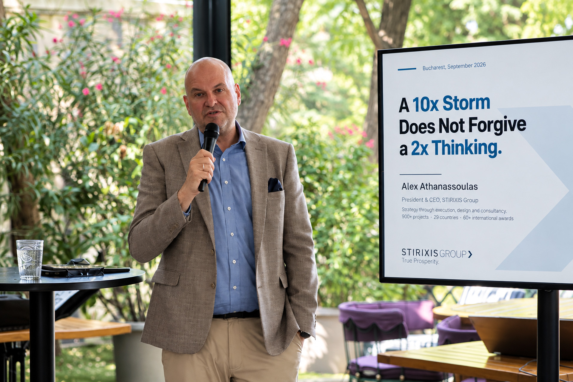 Alex Athanassoulas, President & CEO of STIRIXIS Group, speaking beside his keynote presentation at CEO Clubs Romania Executive Club in Bucharest, September 2026.